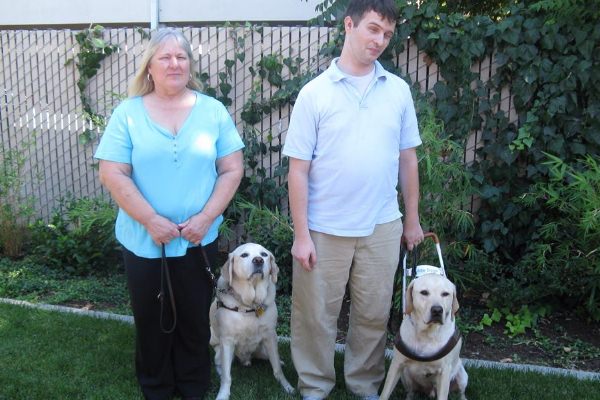 Community Center for the Blind and Visually Impaired IndependentLiving Skills Instructor Laurie and Adaptive Technology Instructor Hy with Guide Dogs Georgio and Fleetwood