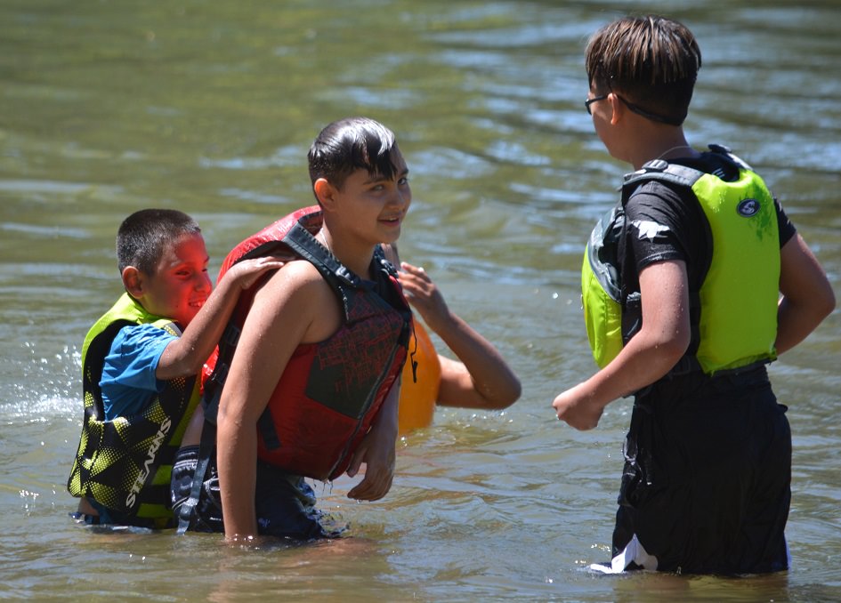 Children Play In The River During Summer Camp