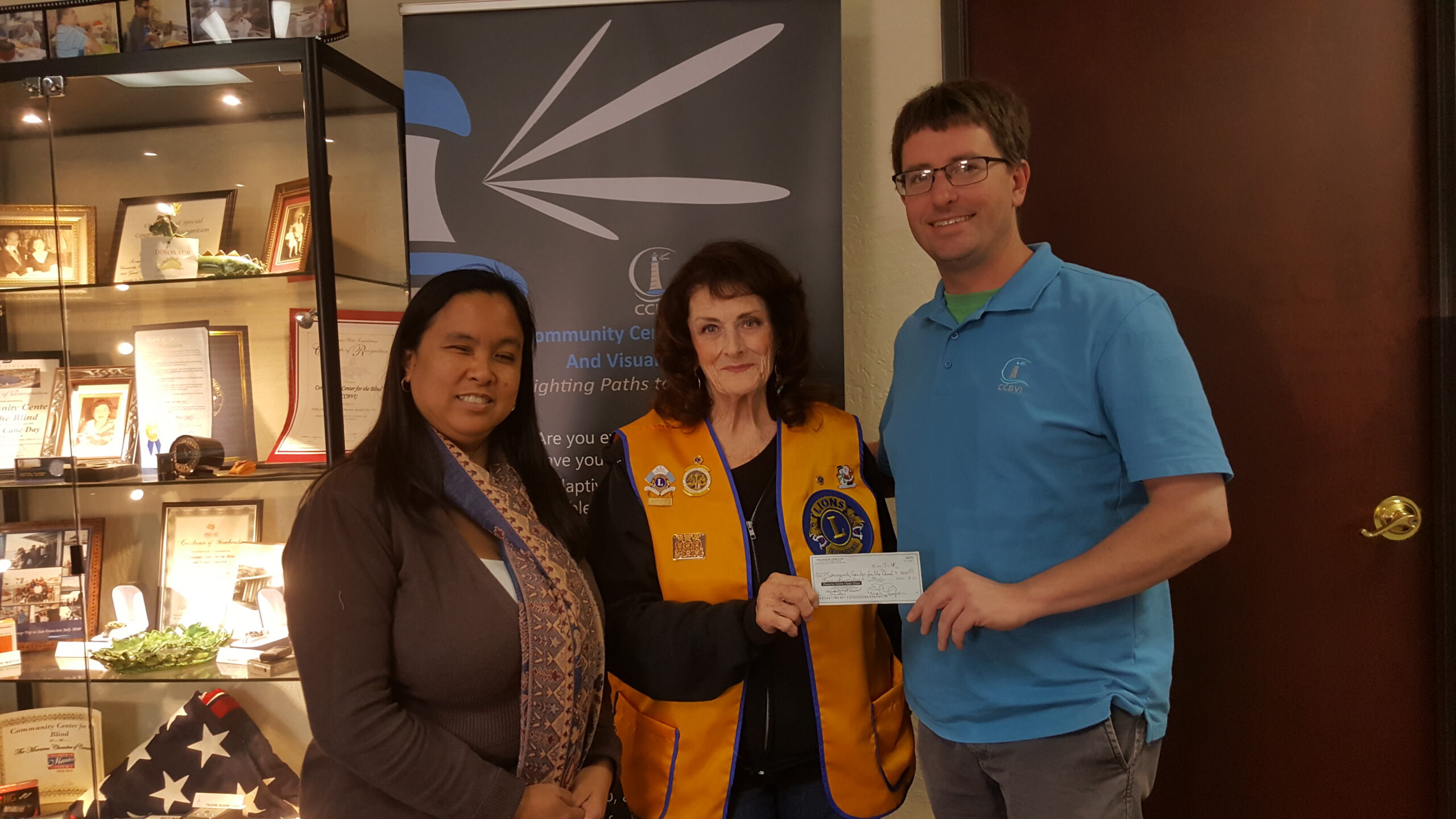 CCBVI Employees Receiving a Check From a Donor 
